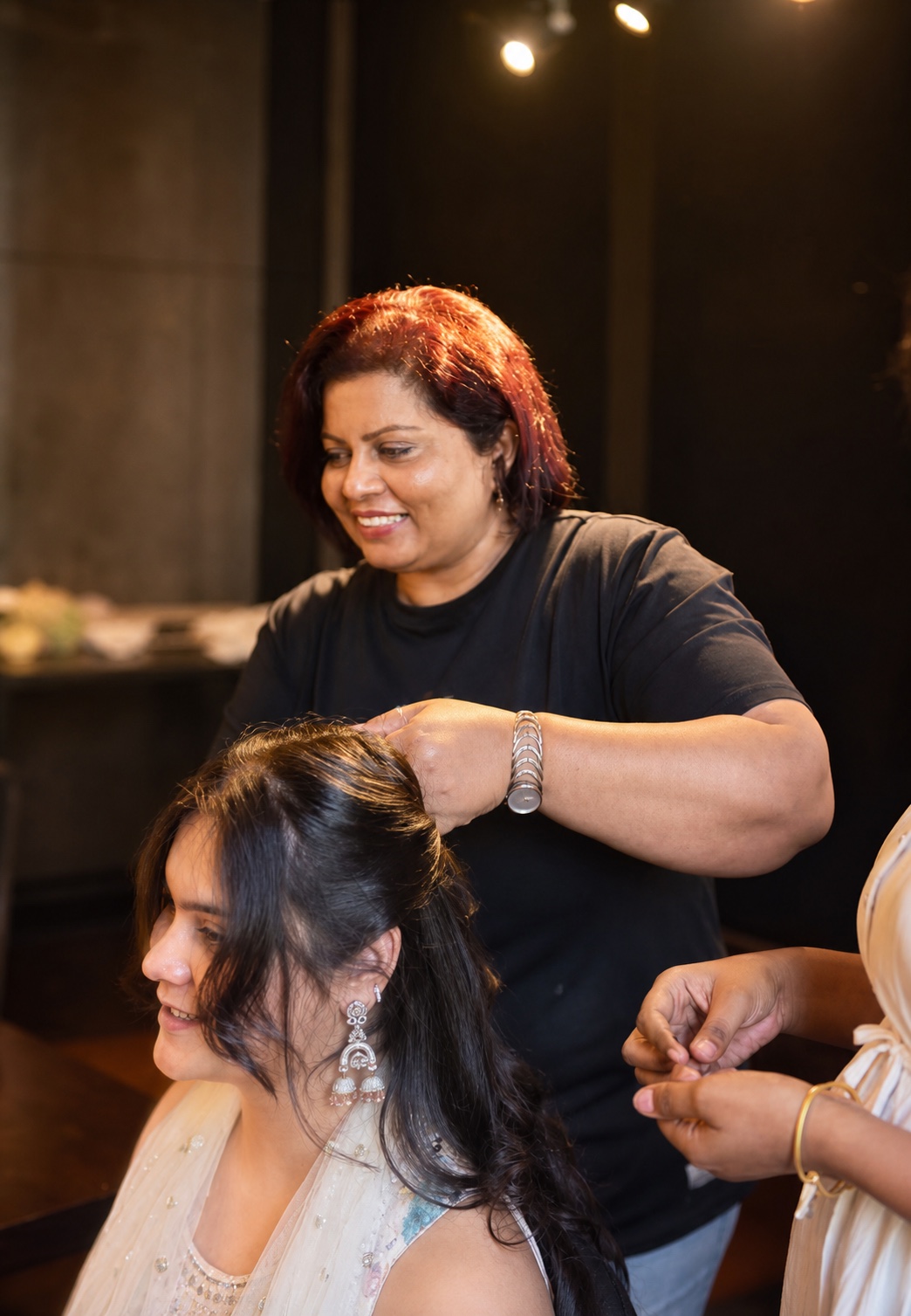 A Salon Nayana stylist finishing a bride's hair in Sri Lanka