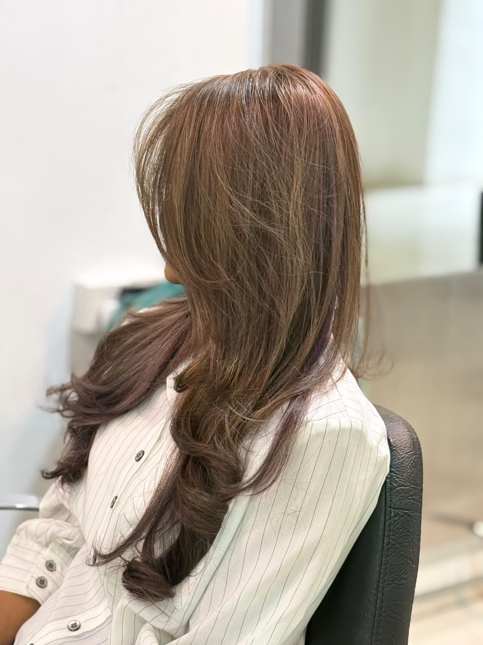 Brunette layered style shown in profile