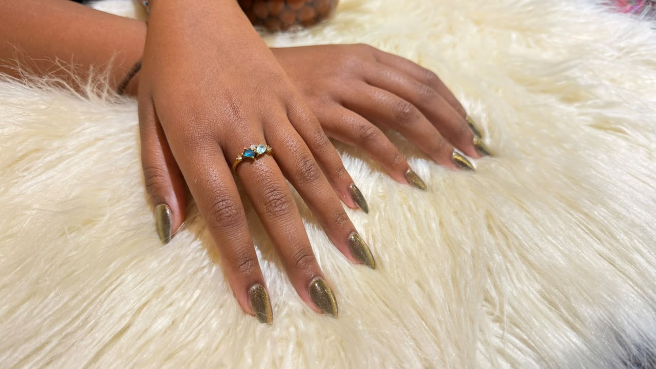 Metallic olive manicure on a soft neutral background